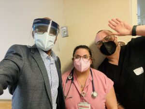 Photograph of professor, nurse preceptor, and nursing student wearing masks